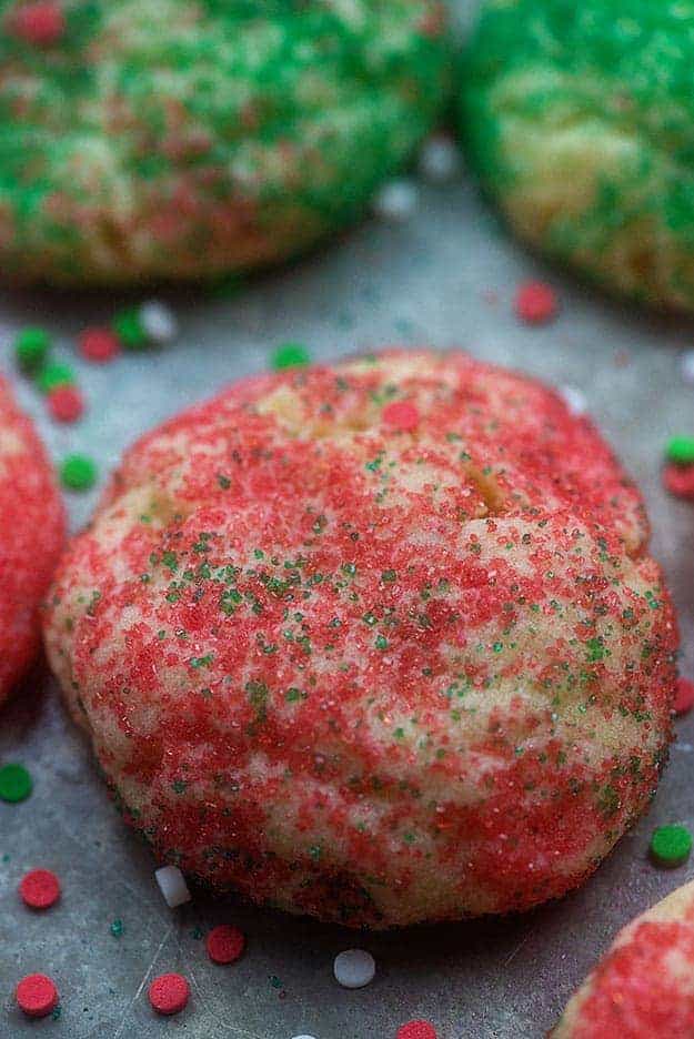 Several sugar cookies on a baking sheet.