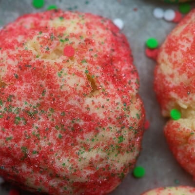 Sugar cookies topped with red sprinkles.