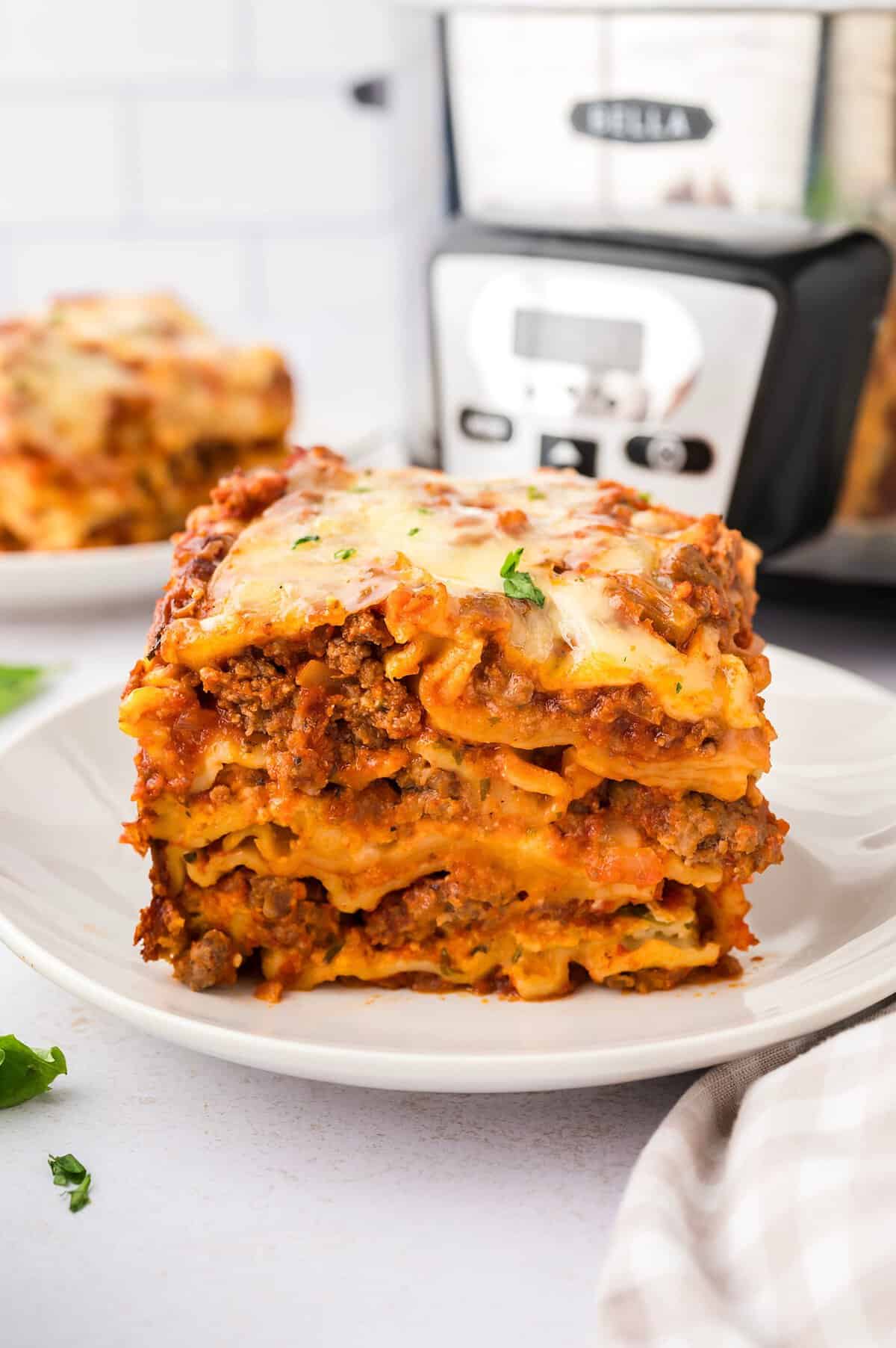 PIece of lasagna on white plate.
