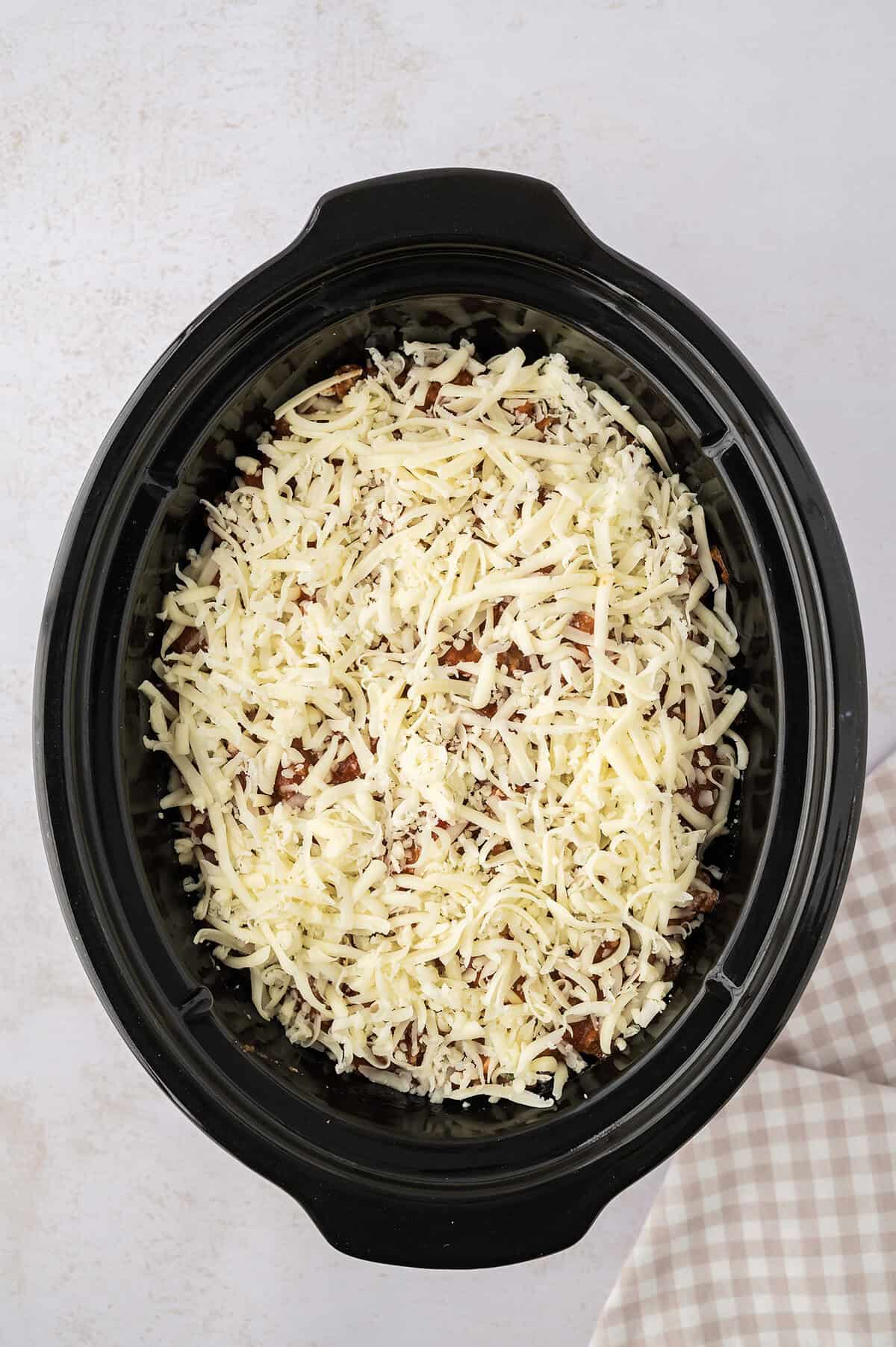 Layered lasagna in crockpot.