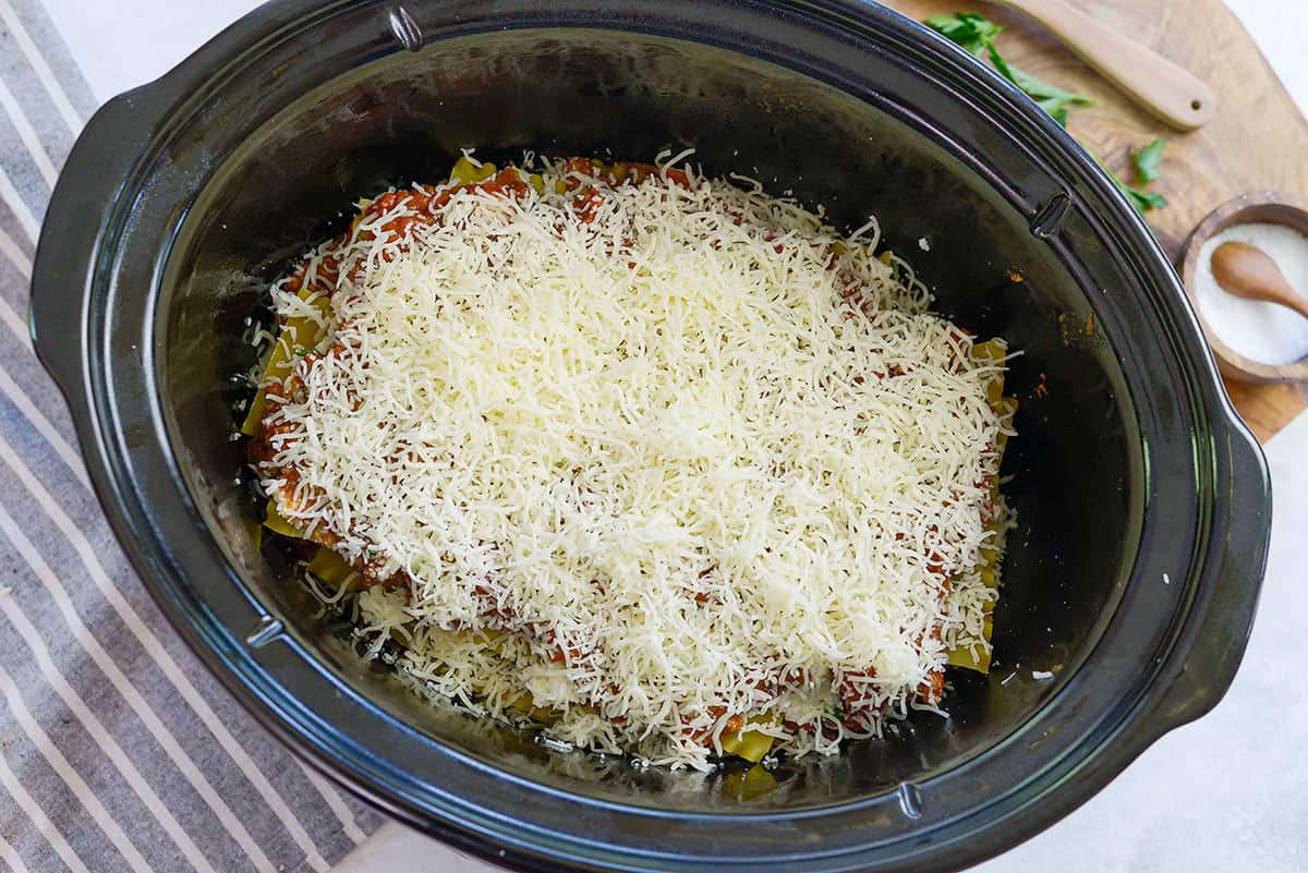 mozzarella cheese on lasagna in crockpot.