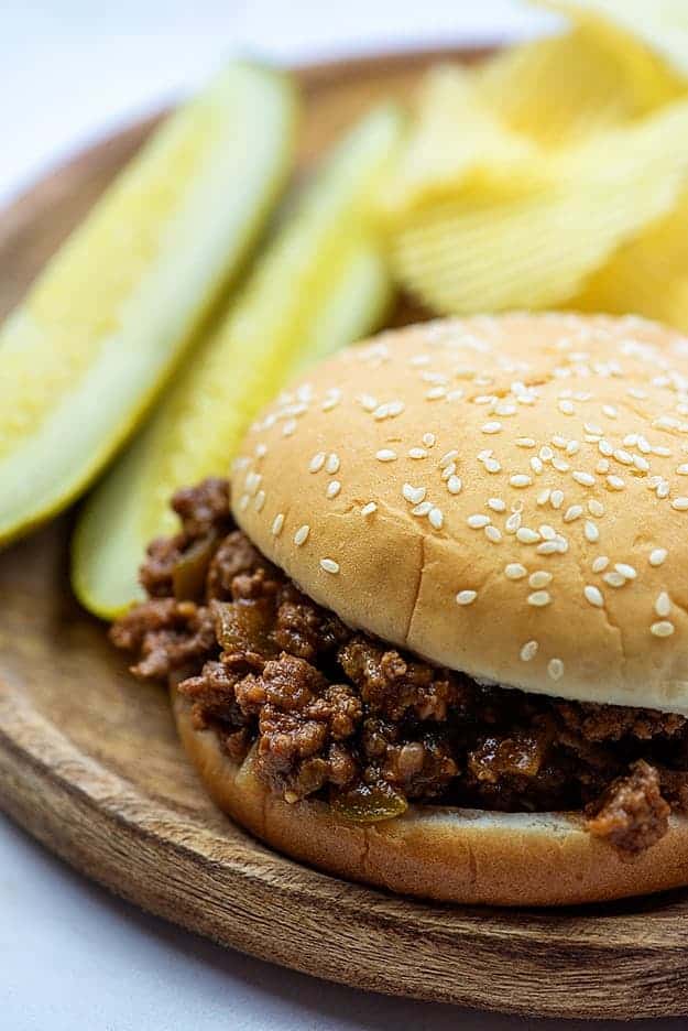 slow cooker sloppy joe meat on bun with pickles