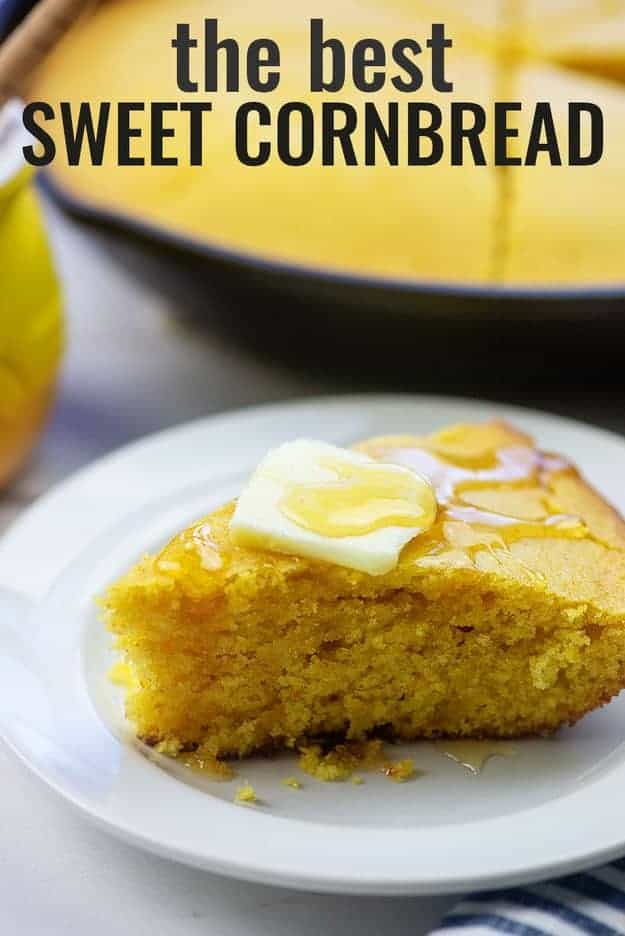 Triangle slice of cornbread with honey and butter on top.
