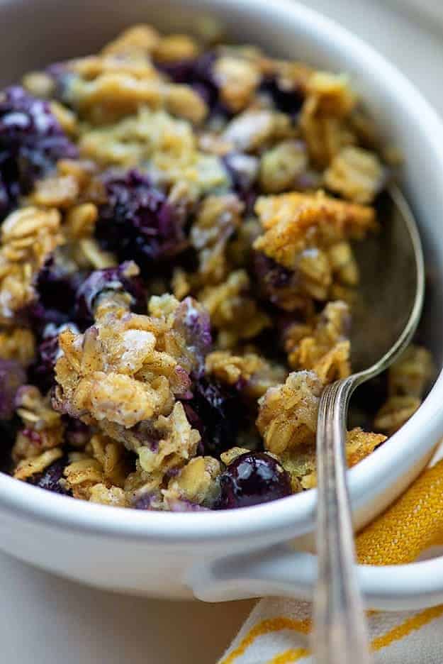 Blueberries in oatmeal in a white bowl.