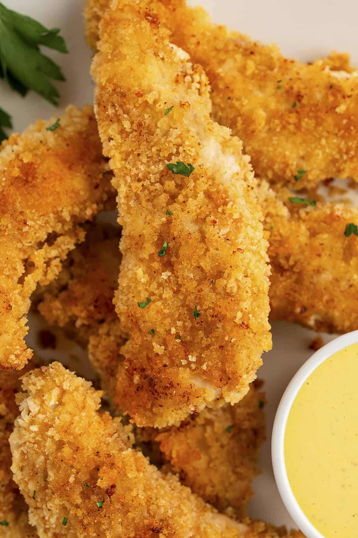 Pile of chicken tenders on plate.