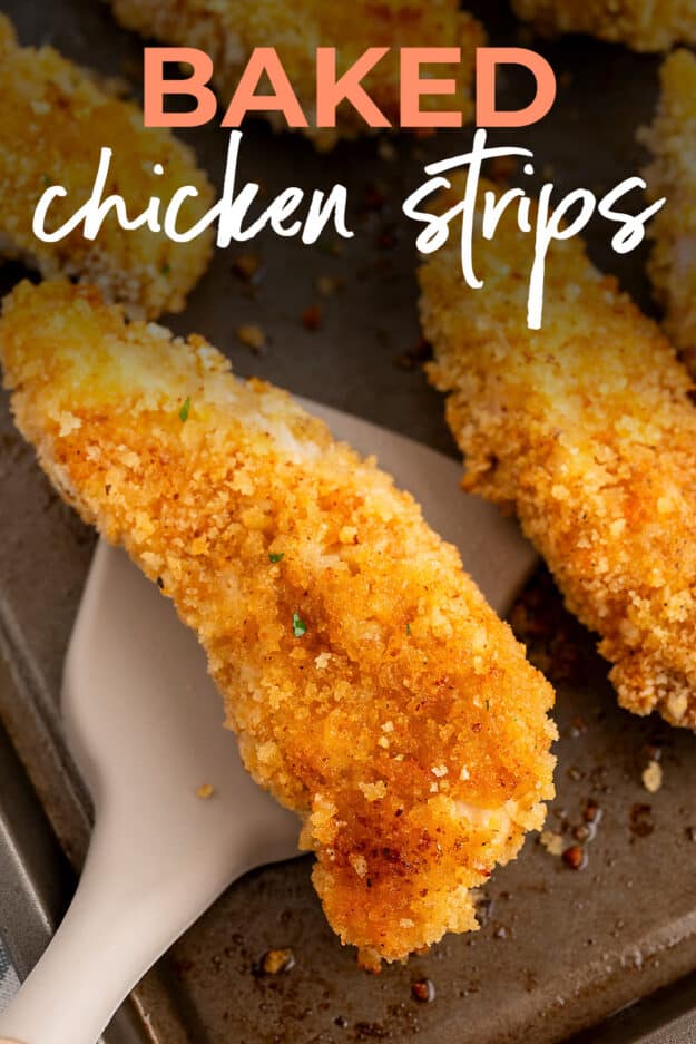 Fried chicken tenders on baking sheet.