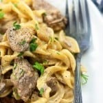 Beef stroganoff on a white plate with a fork.
