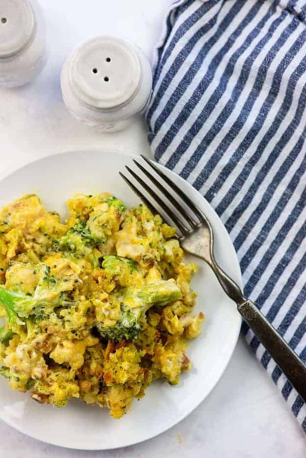 chicken broccoli casserole recipe on white plate with blue striped napkin