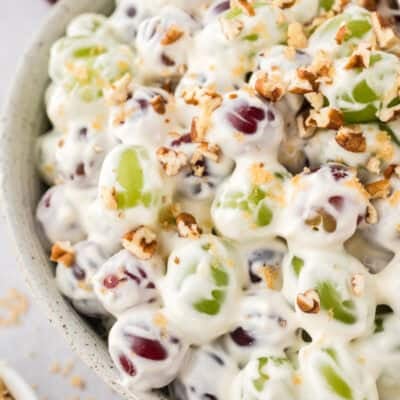 grape salad with cream cheese in yellow bowl