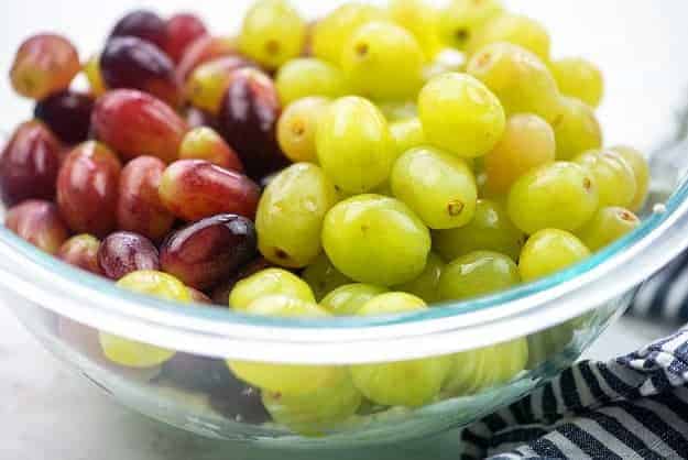 red and green grapes in glass bowl