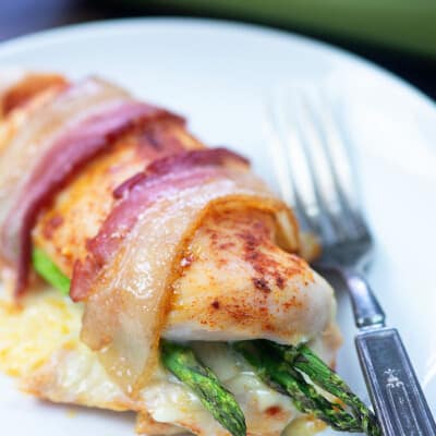 asparagus stuffed chicken on white plate