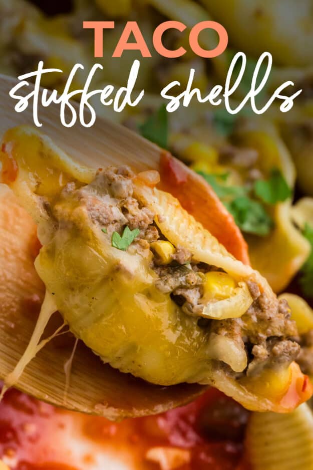 Taco stuffed shell on wooden spoon.