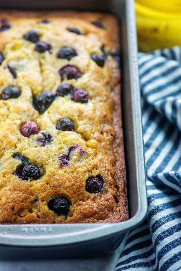 A close up of a banana blueberry bread cooked on a baking sheet.