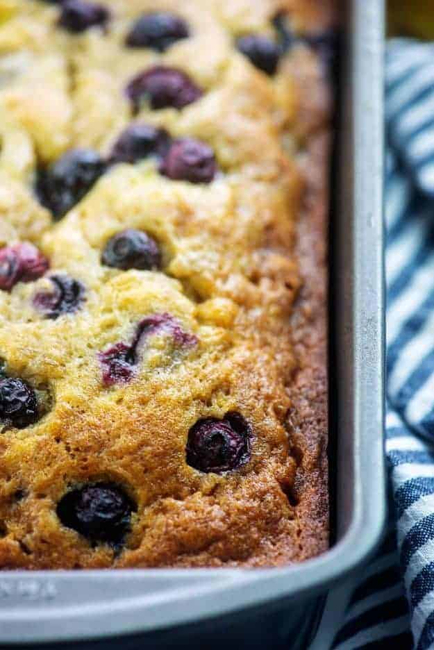 banana bread with blueberries in metal loaf pan