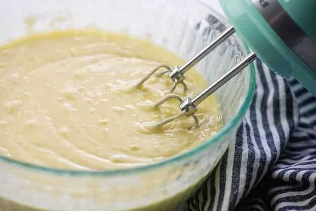 cinnamon roll cake batter in glass mixing bowl
