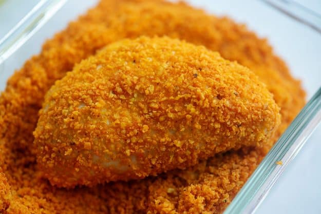 taco pocket coated in doritos crumbs in glass dish