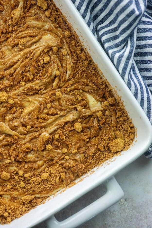 cinnamon and sugar swirled into cake batter in white baking dish