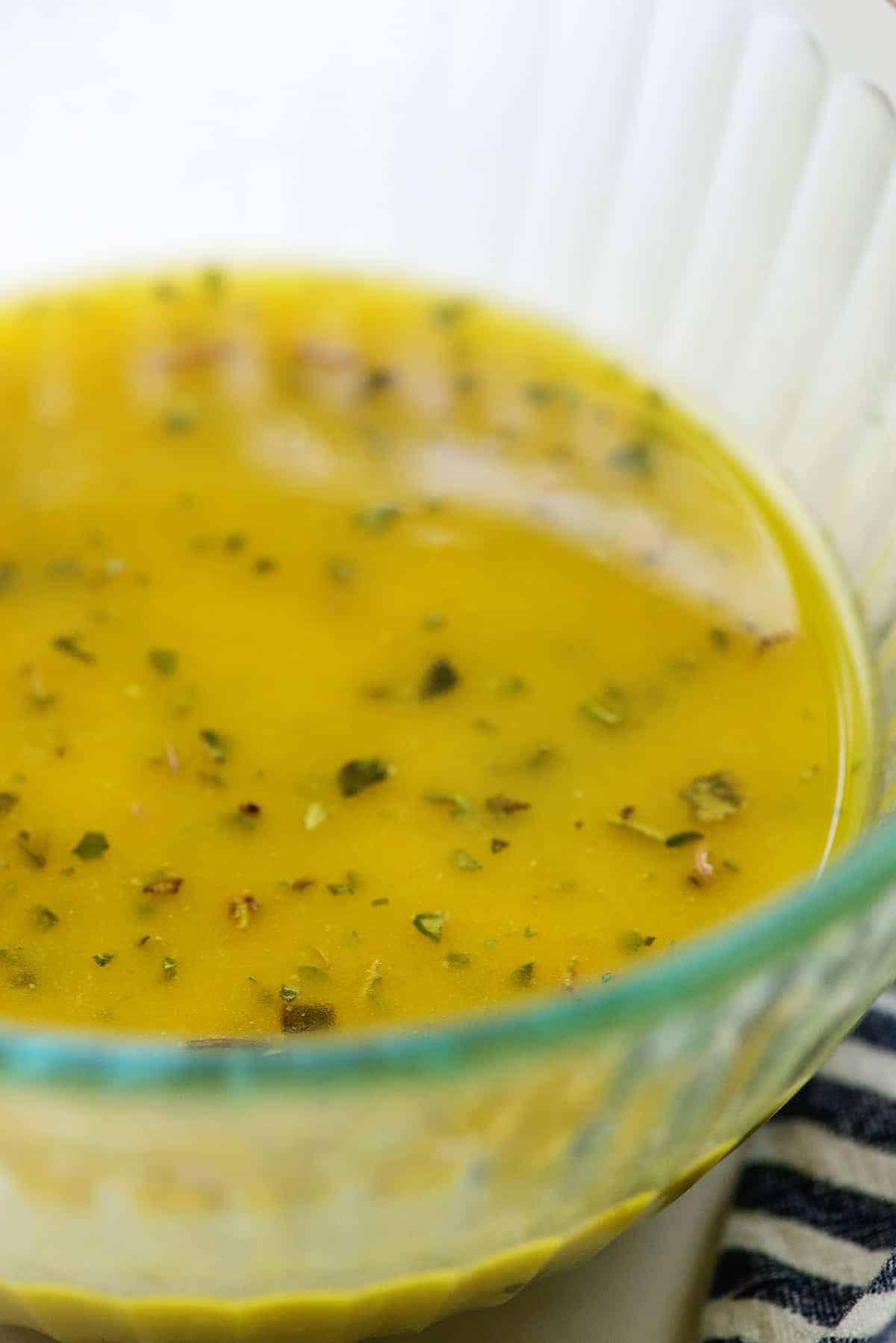 homemade Greek salad dressing in glass bowl