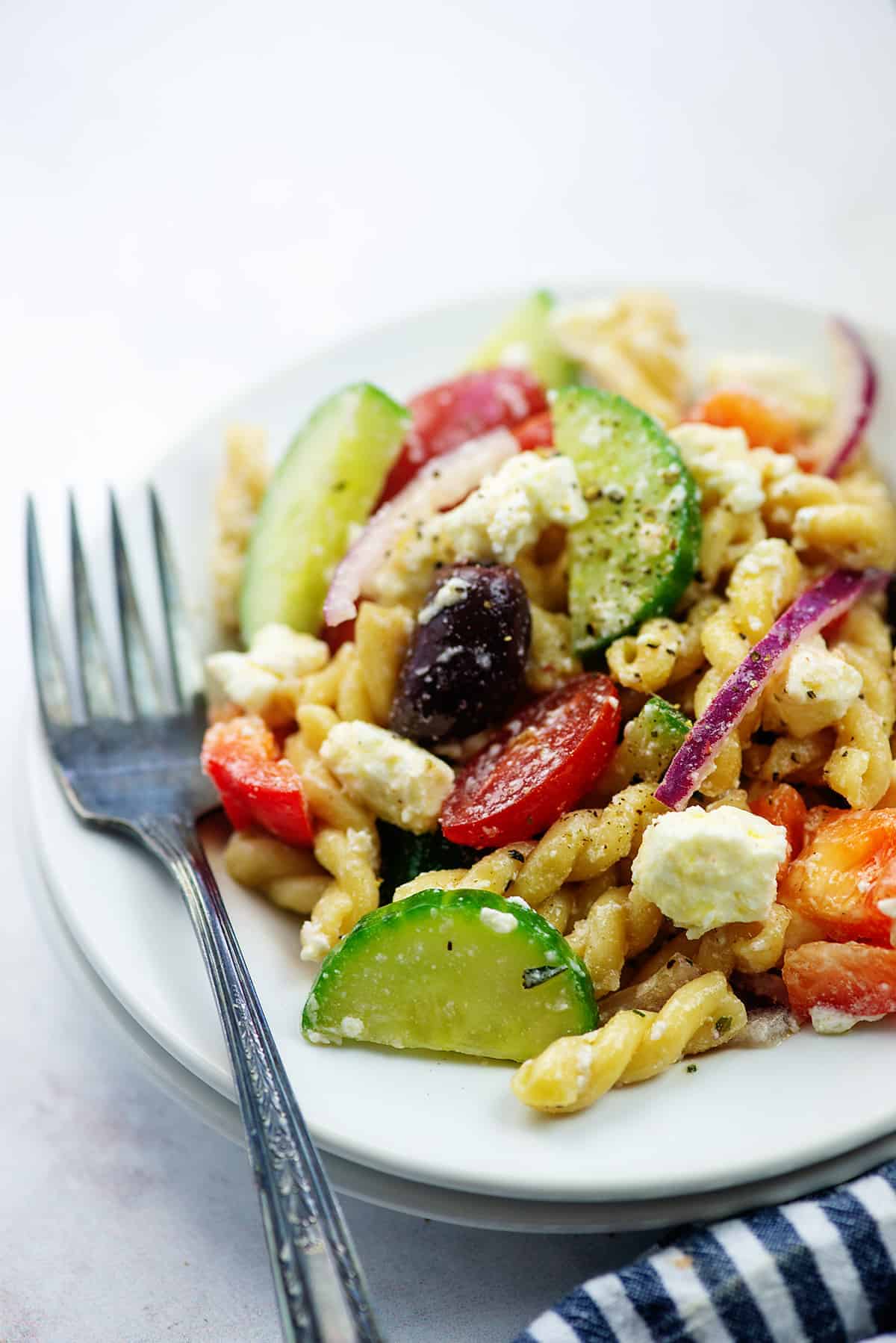 Greek pasta salad recipe on plate with vintage fork