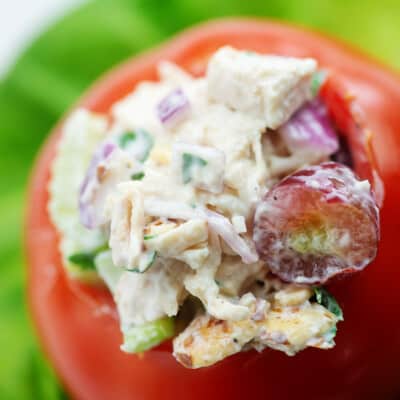chicken salad with grapes stuffed inside a tomato