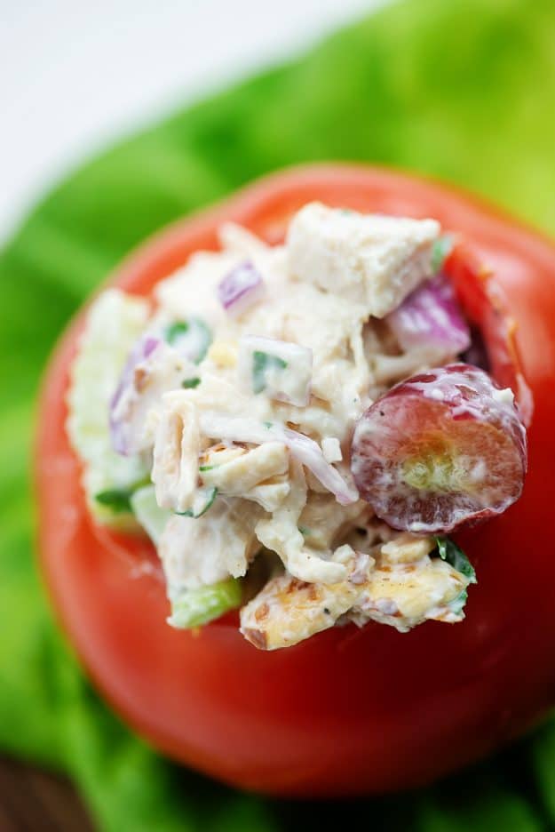 chicken salad with grapes stuffed inside a tomato