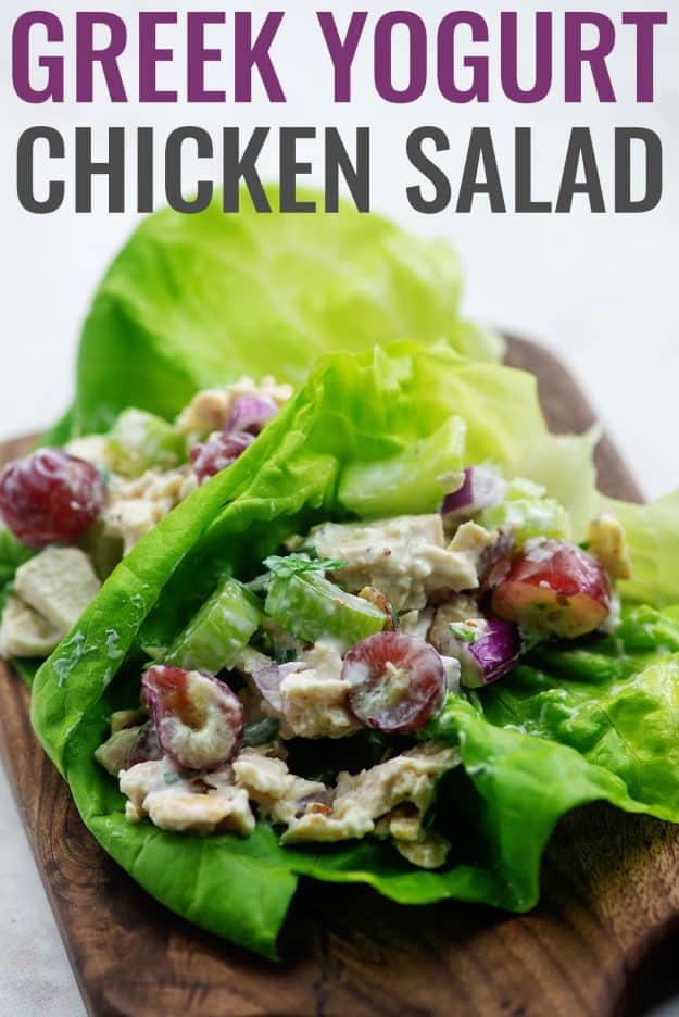 chicken salad with grapes and celery in lettuce wraps on wooden cutting board