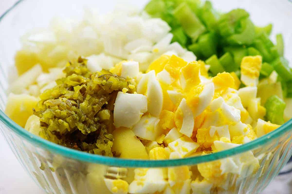 ingredients for amish potato salad in glass mixing bowl