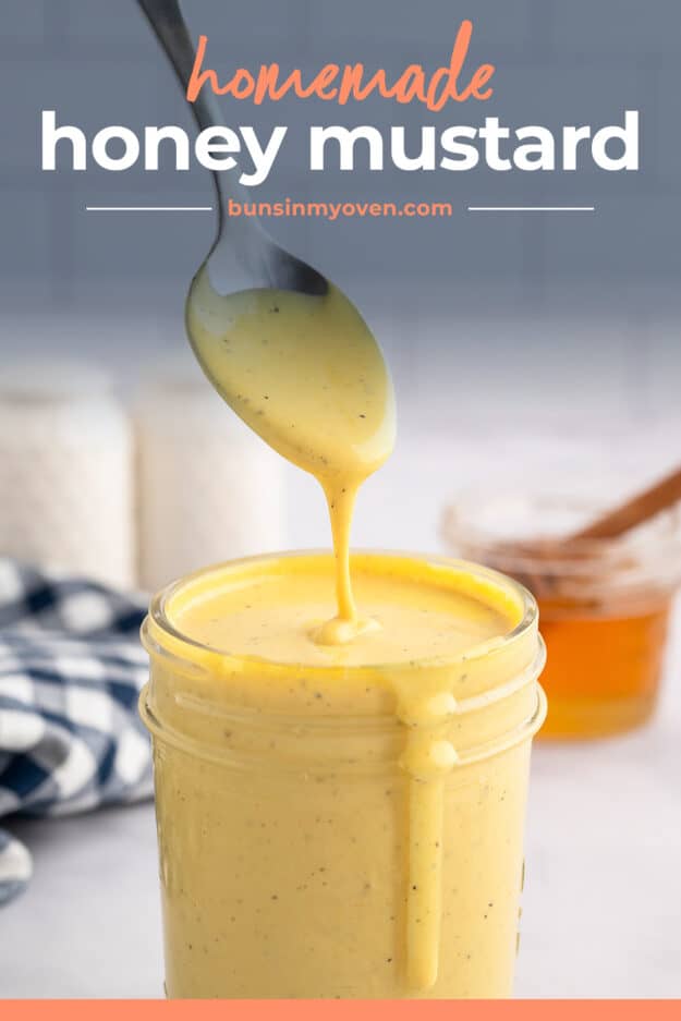 Homemade honey mustard dressing dripping off spoon.