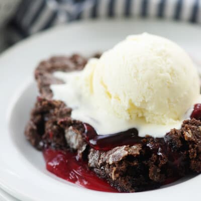 chocolate strawberry cake with scoop of vanilla ice cream on top