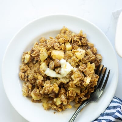 baked oatmeal recipe on white plate with blue striped napkin and vintage fork