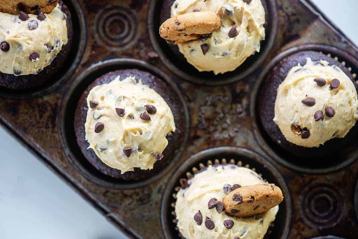 cupcakes in metal cupcake tin with cookie dough frosting on top