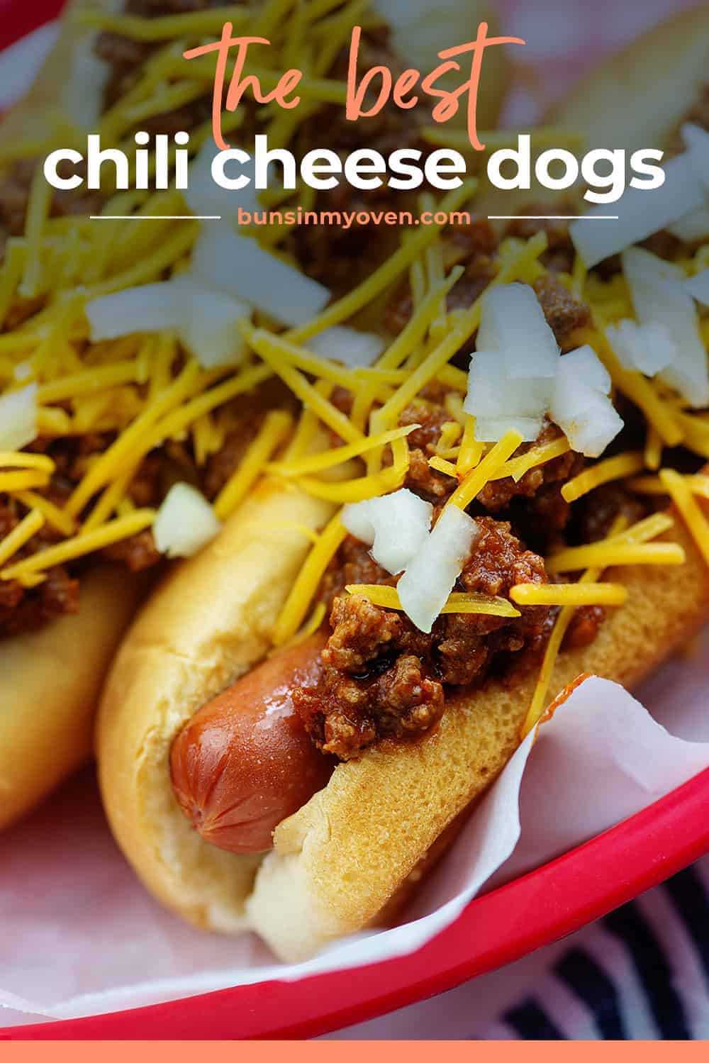 chili cheese dogs in red basket with onions on top