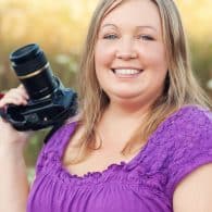 karly campbell holding a camera in a field