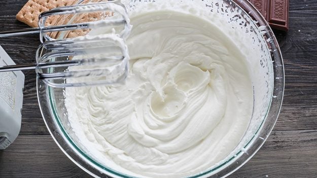 whipped cream in glass bowl