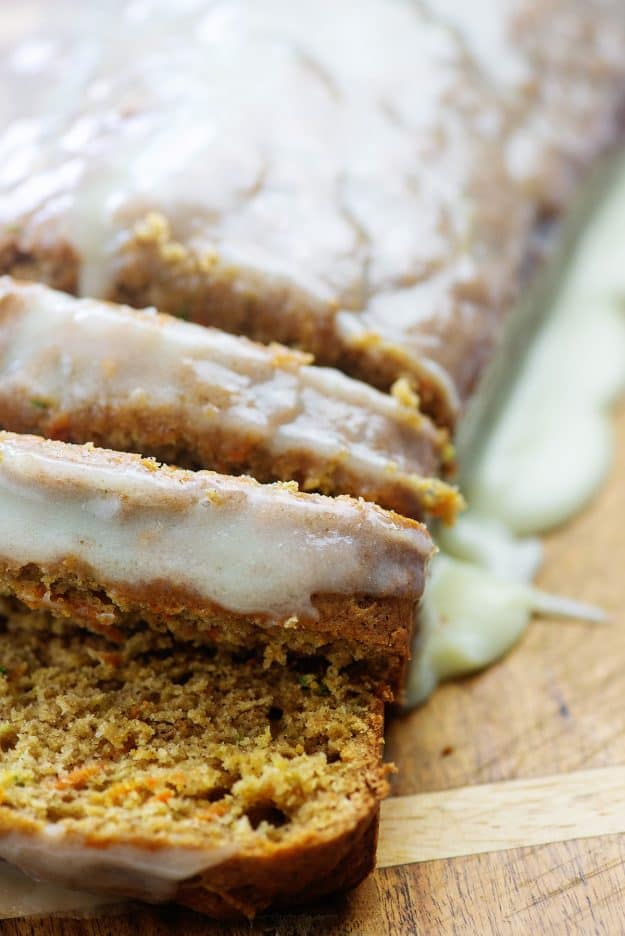 cream cheese glazed zucchini bread on wooden cutting board