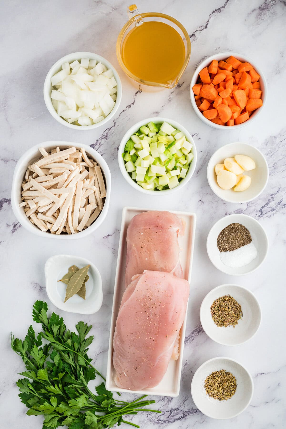 Ingredients for crockpot chicken noodle soup laid out on counter.