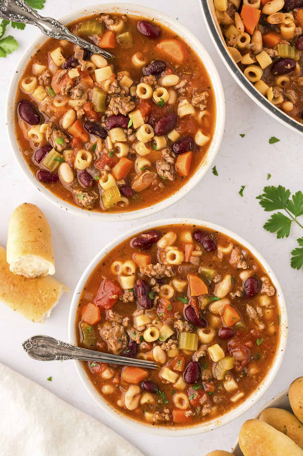 Bowls filled with pasta fagioli soup.