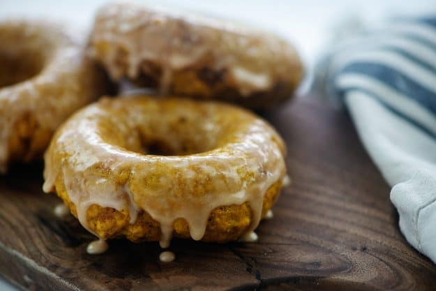 glazed donuts on wooden cutting board