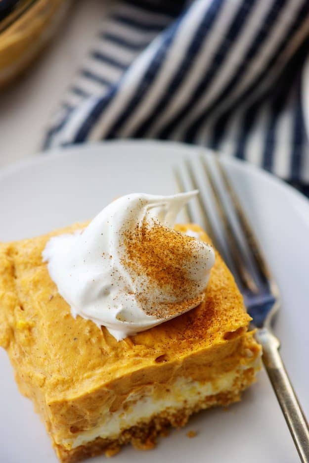 layered pumpkin dessert on white plate with fork