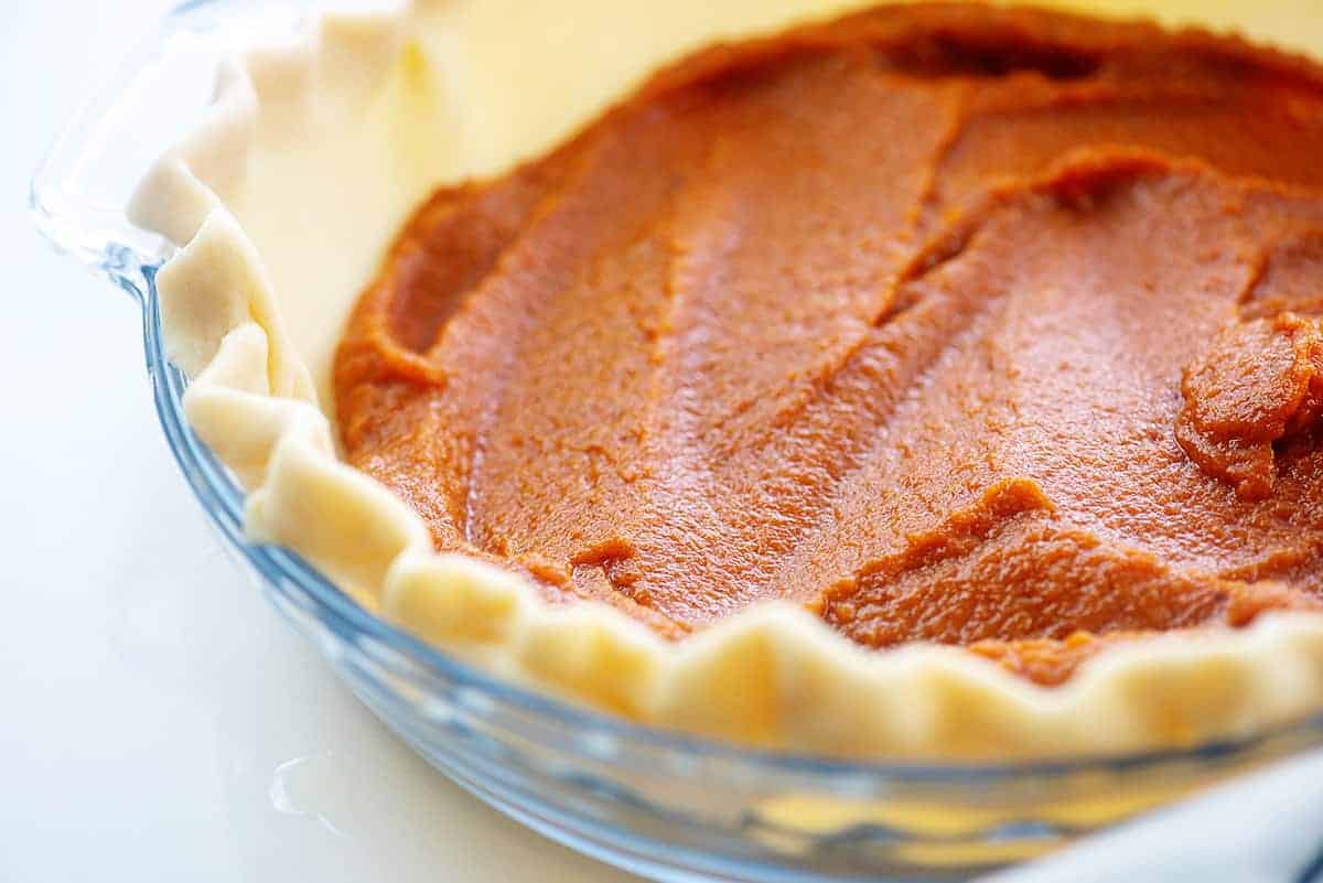 layer of pumpkin filling in pie crust