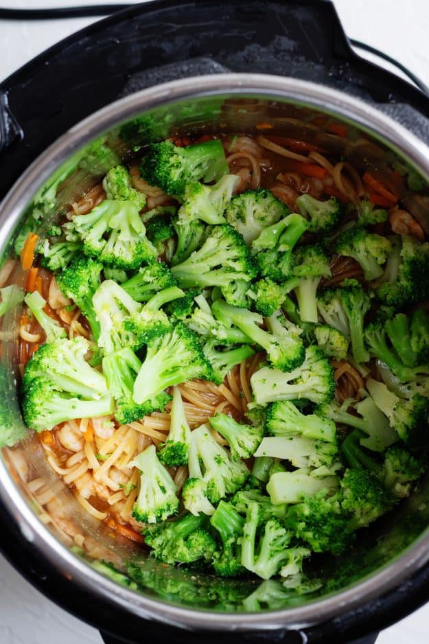 Instant Pot full of noodles and broccoli.