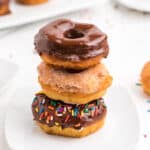 Biscuit donuts stacked on plate.