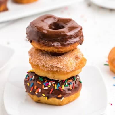 Biscuit donuts stacked on plate.