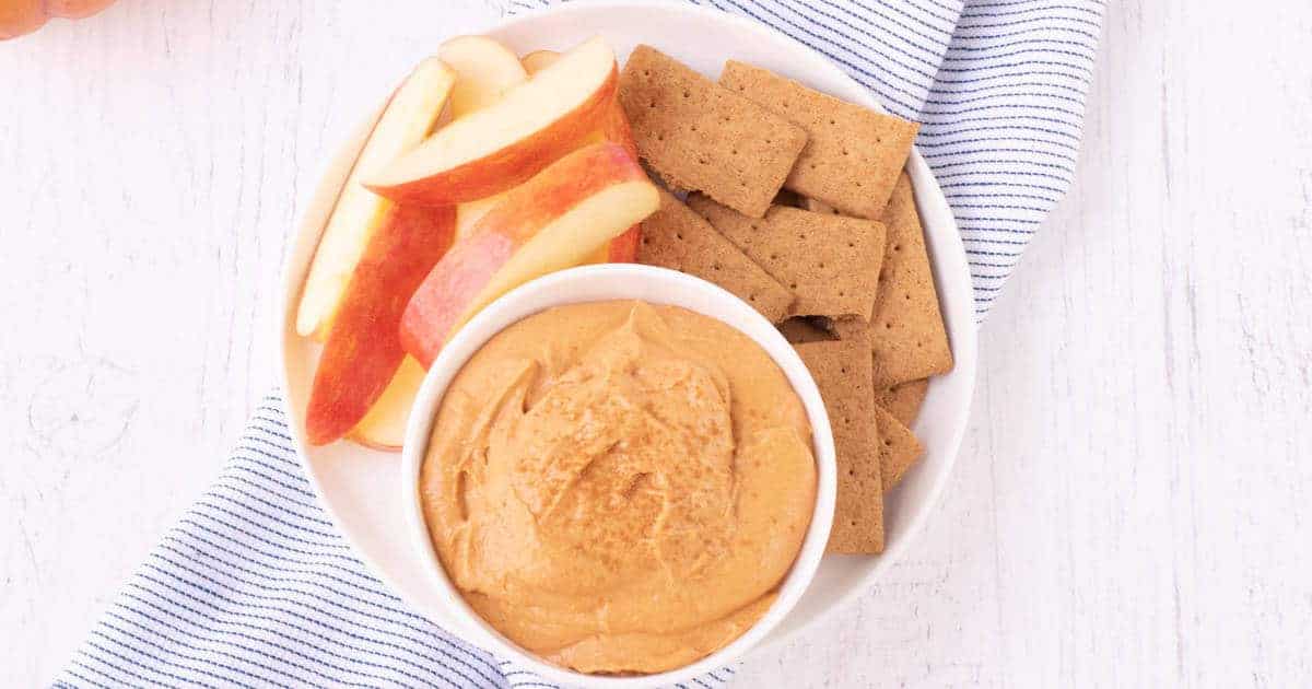 pumpkin cheesecake dip in white bowl.