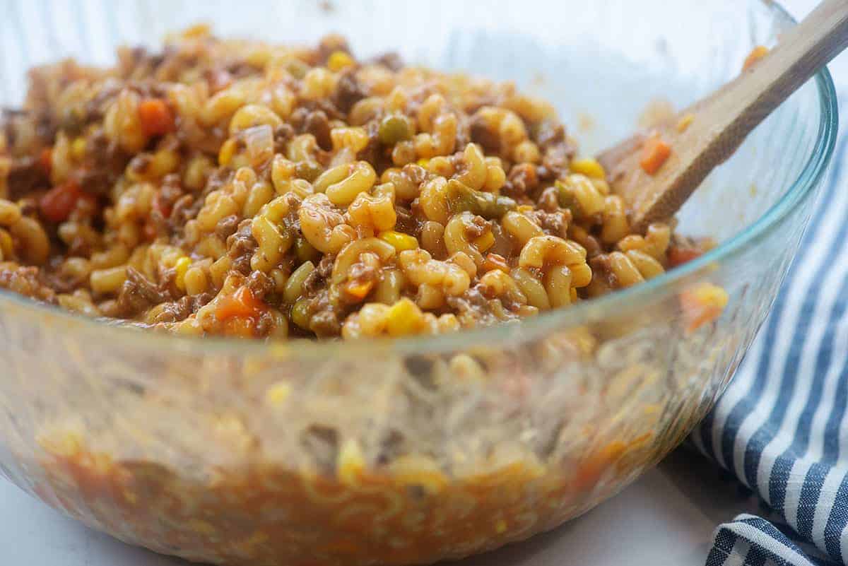 ingredients for hamburger casserole in glass bowl.