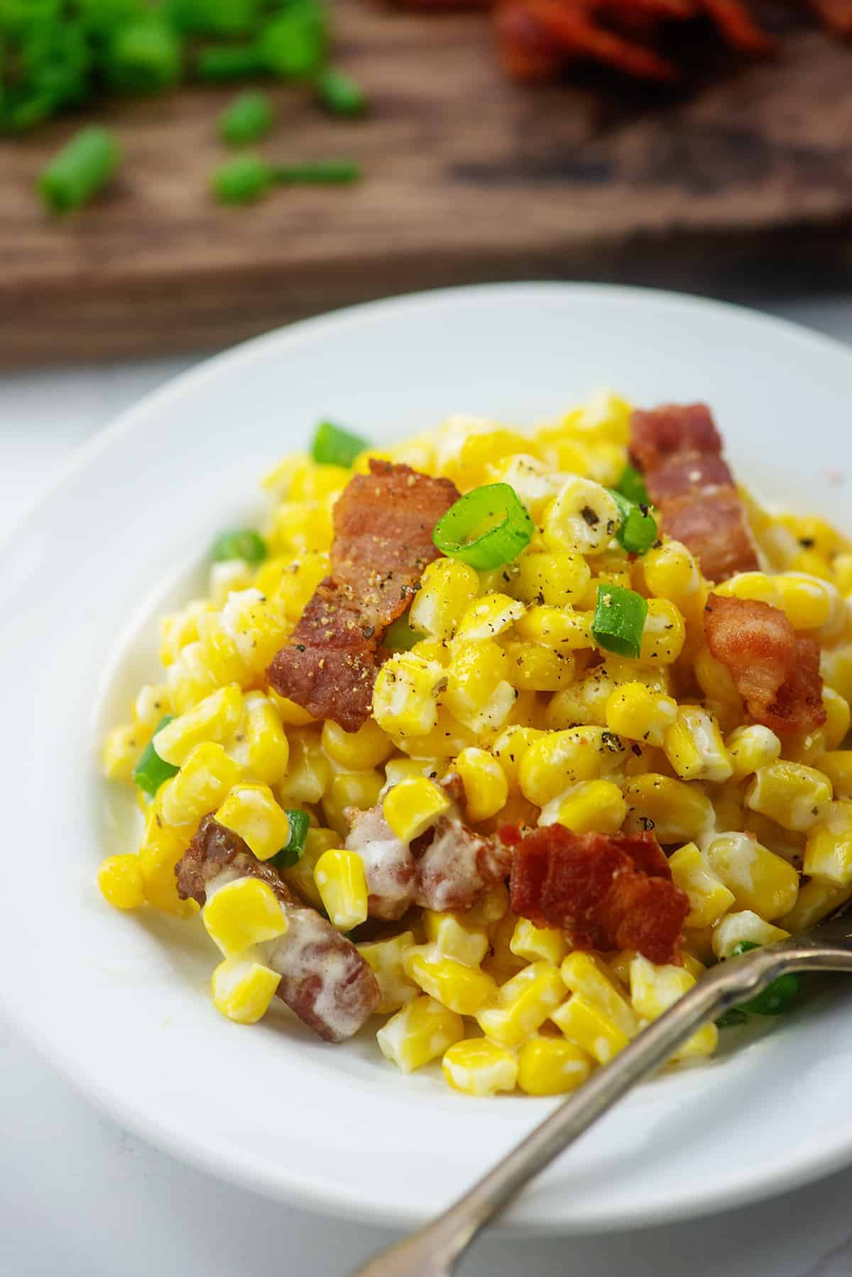 plateful of cream cheese corn with bacon.