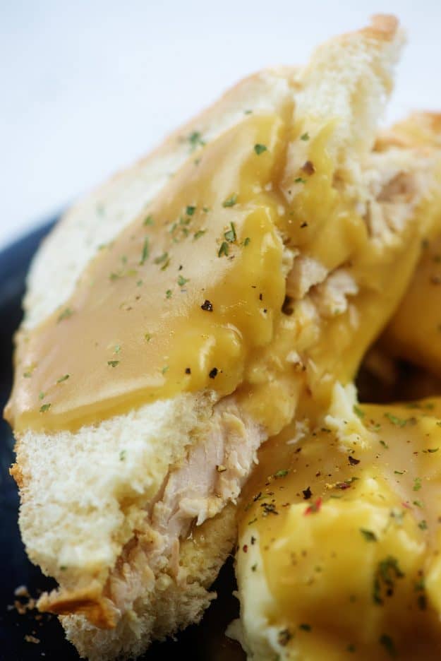 turkey sandwich topped with gravy.