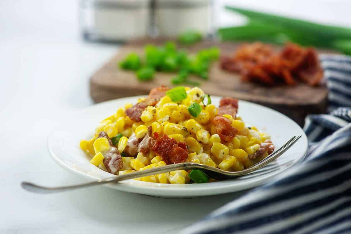 creamed corn on white plate.