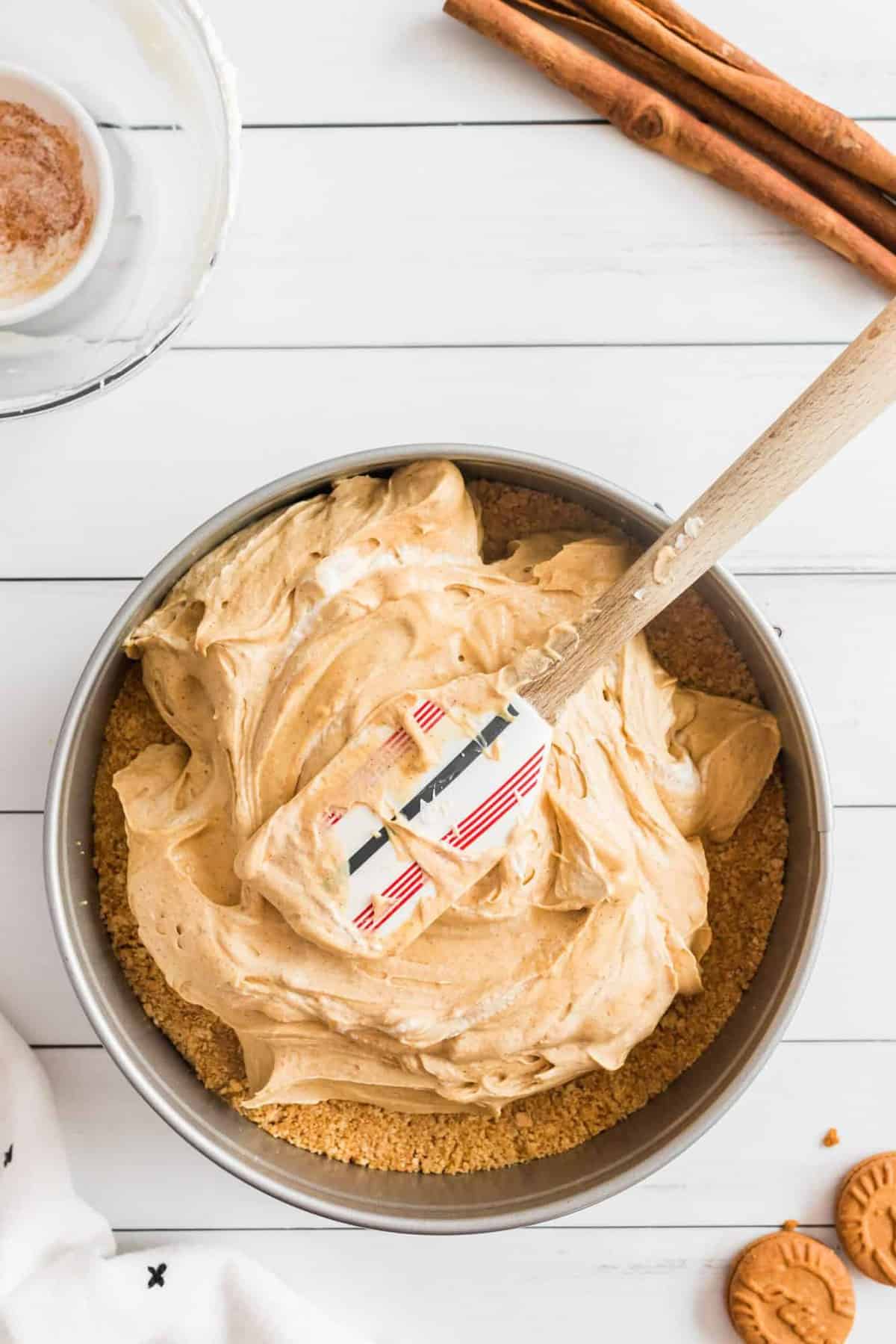 gingerbread cheesecake batter spread in springform pan.