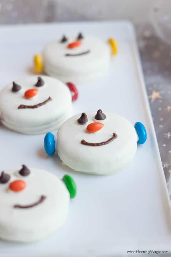 snowman cookies on white plate.